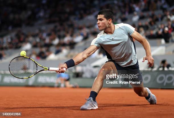 Carlos Alcaraz of Spain plays a backhand against Karen Khachanov during the Men's Singles Fourth Round match on Day 8 of The 2022 French Open at...