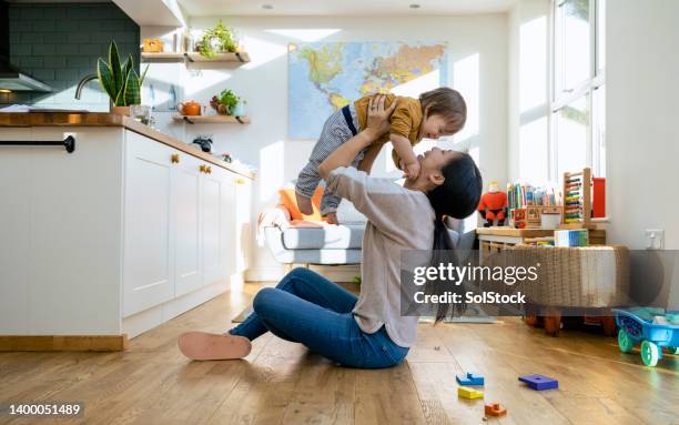 mother's baby boy! - sitting on floor bildbanksfoton och bilder