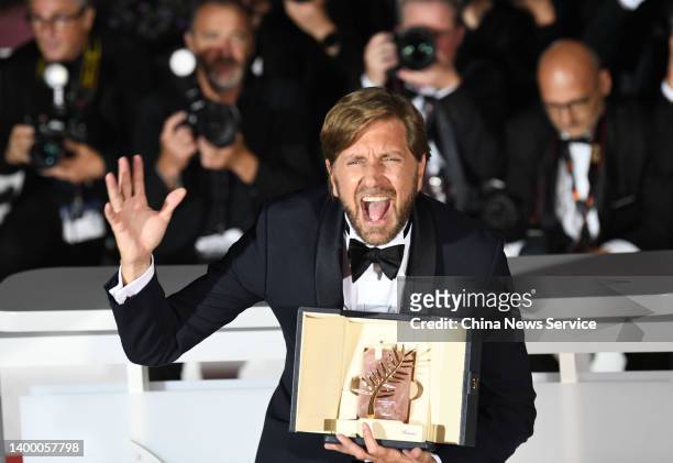 Director Ruben Ostlund poses with the Palme d'Or Award for "Triangle of Sadness" at the winner photocall during the 75th annual Cannes film festival...