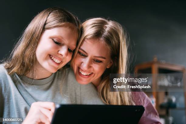 girl showing her art to her mother - 14 year old blonde girl stock pictures, royalty-free photos & images