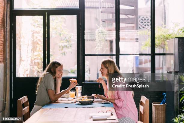 mother and daughter eating their breakfast at home - teenagers eating with mum stock pictures, royalty-free photos & images