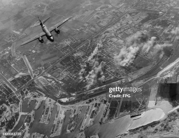 Martin B-26 Marauder twin-engined medium bomber from the 386th Bombardment Group United States Army Air Forces 8th Air Force, drop their payload of...