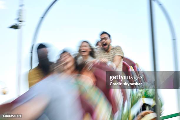 rollercoaster ride in blurred motion! - rollercoaster scream stock pictures, royalty-free photos & images