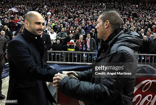 Head coach Josep Guardiola of Barcelona shakes hands with head coach Diego Simeone of Atletico Madrid prior of the La Liga match at Vicente Calderon...