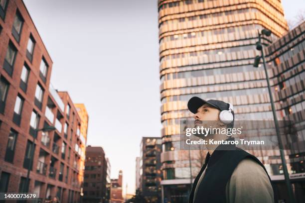 portrait of a man with headphones in city environment - malmo sweden stock pictures, royalty-free photos & images