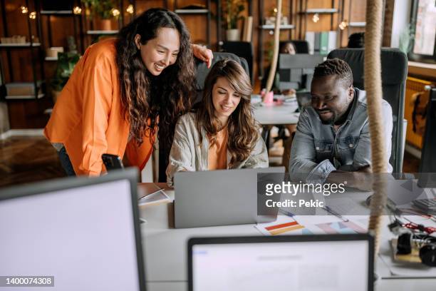 designers at work - co workers looking at computer stockfoto's en -beelden