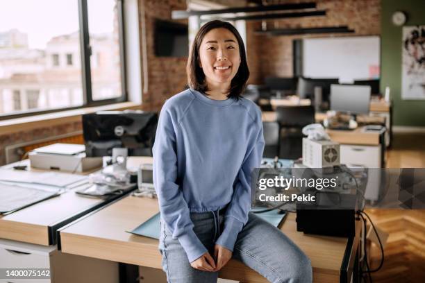 young woman posing in the office - korean people stock pictures, royalty-free photos & images
