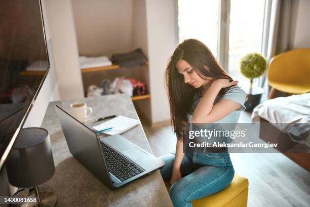 shoulder pain for female designer after working on laptop for too long - zoom fatigue stock pictures, royalty-free photos & images