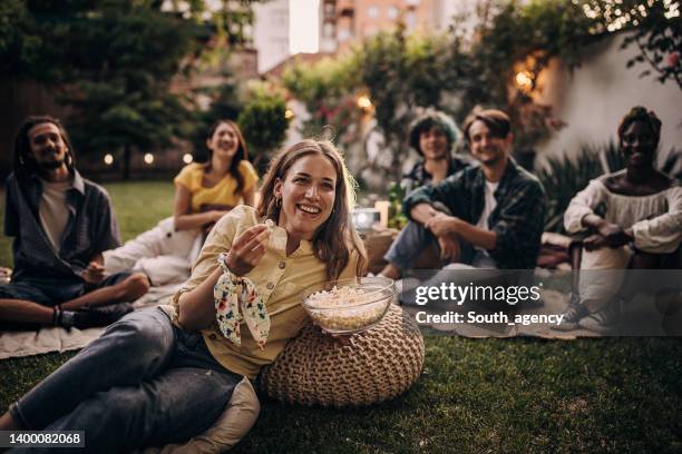 friends watching movie on the video projector in the backyard garden - backyard movie stock pictures, royalty-free photos & images