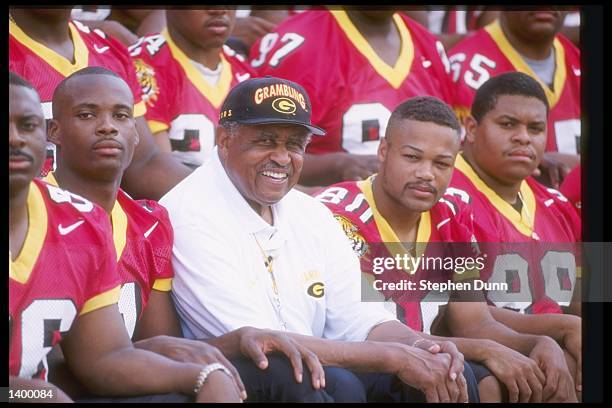 Coach Eddie Robinson of the Grambling State Tigers sits with his team during Media Day in Grambling, Louisiana.