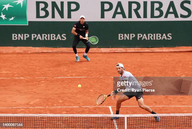 Jean-Julien Rojer of Netherlands plays a forehand as partner Marcelo Arevalo of El Salvador looks on against Rafael Matos of Brazil and David Vega...