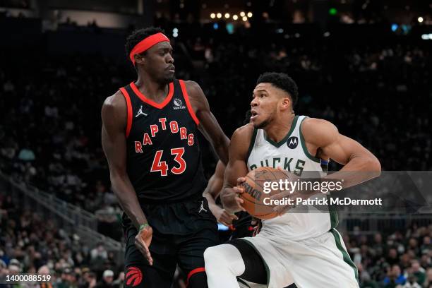 Giannis Antetokounmpo of the Milwaukee Bucks goes to the basket against Pascal Siakam of the Toronto Raptors in the first half at Fiserv Forum on...