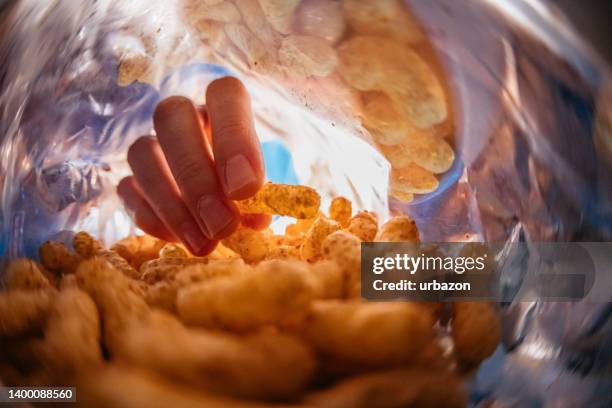 young man eating flips from the bag's pov - hand wide angle stock pictures, royalty-free photos & images