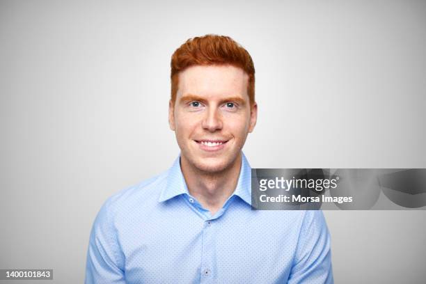confident young redhead entrepreneur in blue shirt - auburn stock pictures, royalty-free photos & images