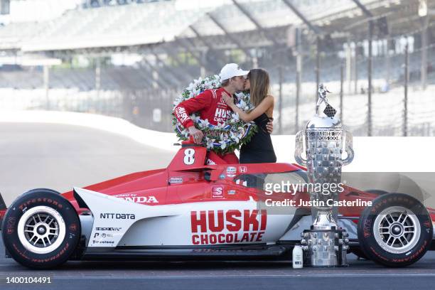 Marcus Ericsson of Sweden poses with girlfriend Iris Tritsaris Jondahl and the Borg-Warner Trophy during the 106th Indianapolis 500 champions...