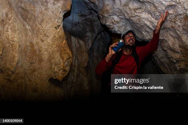 trekking man in a cave, exploration - speleology stock pictures, royalty-free photos & images