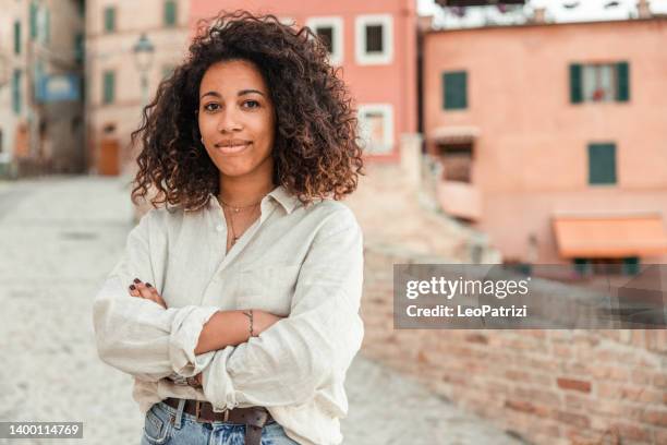 portrait of a woman posing while on vacation in a small town in italy - dominican ethnicity stock pictures, royalty-free photos & images