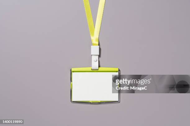 blank id tag with green lanyard close-up view - charakter stock-fotos und bilder