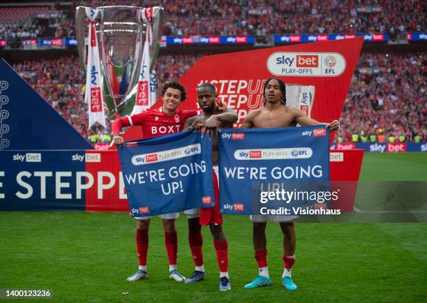 Brennan Johnson, Keinan Davis and Djed Spence of Nottingham Forest celebrate with WE'RE GOING UP banners following the Sky Bet Championship Play-Off...