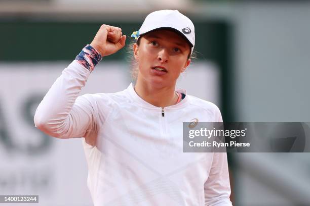 Iga Swiatek of Poland celebrates match point against Qinwen Zheng of China during the Women's Singles Fourth Round match on Day 9 of The 2022 French...