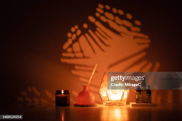 aromatherapy with himalayan salt lamp at sunset - healing crystals stock pictures, royalty-free photos & images
