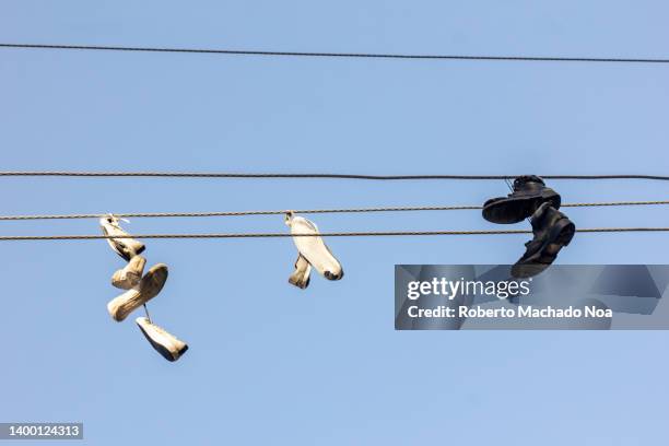 shoes tangled in electric cables - vandalisme stockfoto's en -beelden