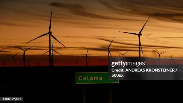 low angle view of windmills against sky during sunset,calama,antofagasta,chile - calama stockfoto's en -beelden