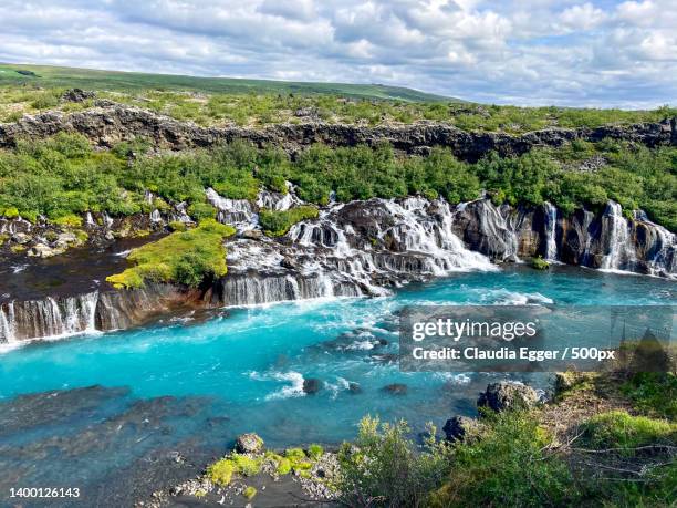 scenic view of sea against sky - hraunfossar stock pictures, royalty-free photos & images