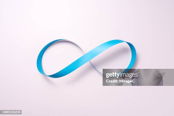 infinity mark made of blue paper strip - lifecycle stock-fotos und bilder
