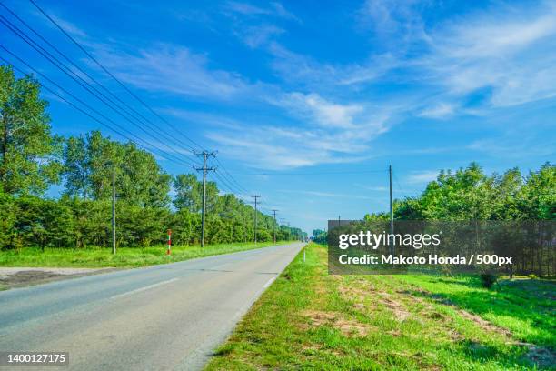 empty road amidst trees against sky - akita prefecture foto e immagini stock