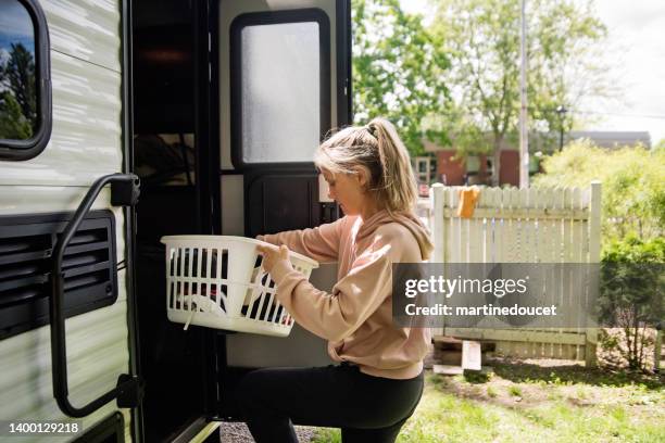 mature woman getting rv ready for summer vacations. - laundry basket stock pictures, royalty-free photos & images