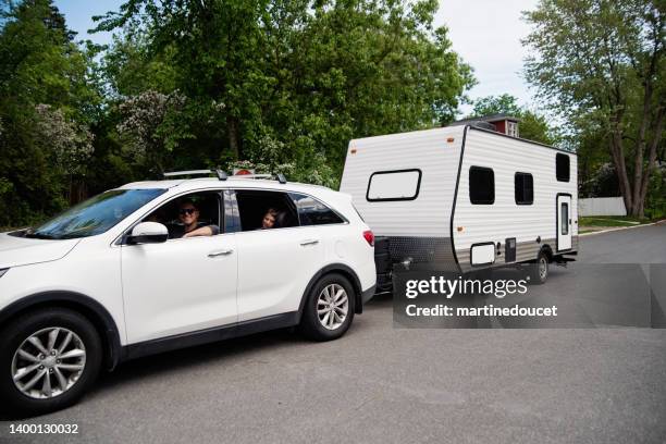 family getting ready to leave with rv for summer vacations. - camper trailer stock pictures, royalty-free photos & images