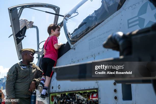 Boy looks into the cockpit of a US Navy helicopter during a visit to the USS Bataan on Memorial Day on May 30, 2022 in New York City. The USS Bataan...