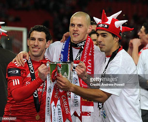 Maxi Rodriguez, Martin Skrtel and Luis Suarez of Liverpool celebrate with the cup at the end of the Carling Cup Final match between Liverpool and...