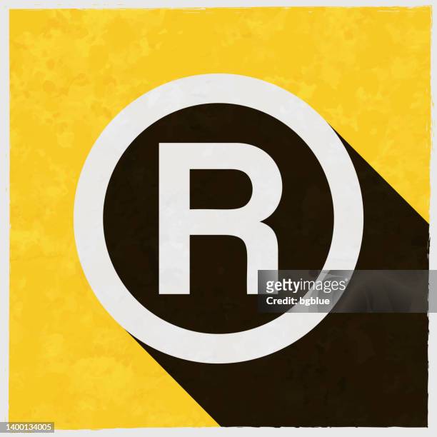 registered trademark. icon with long shadow on textured yellow background - r logo stock illustrations