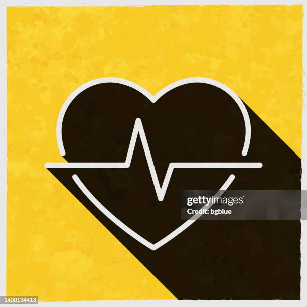 heartbeat - heart pulse. icon with long shadow on textured yellow background - defibrillator stock illustrations