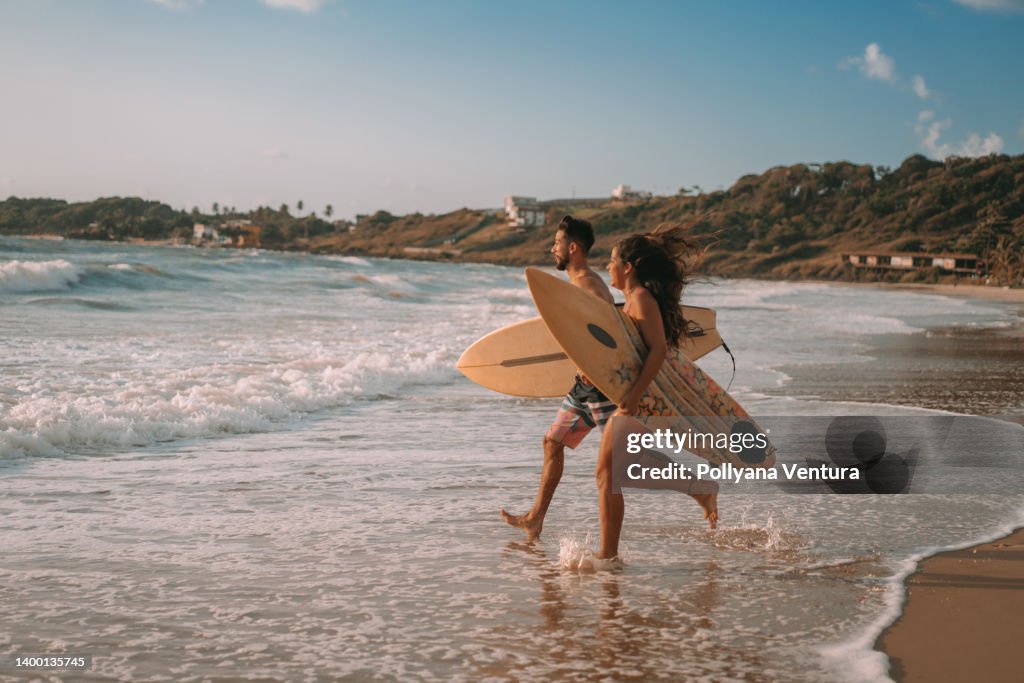 Couple running to the sea