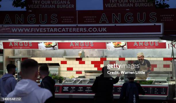 Burger van chef hands the match ball back to fans after it landed inside his mobile vending unit after being hit for a six during the Vitality T20...