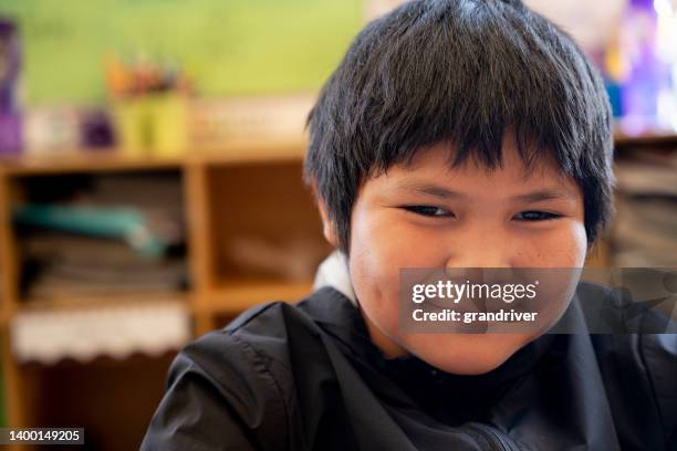 happy elementary age boy portrait in a grade school classroom - indian school students stock pictures, royalty-free photos & images