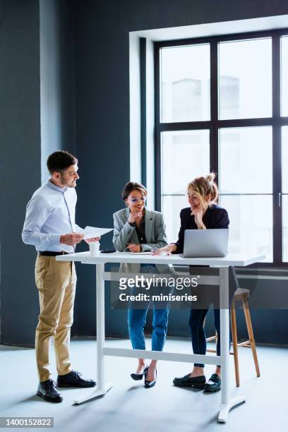 group of smiling businesspeople working together at their company - three people office stock pictures, royalty-free photos & images
