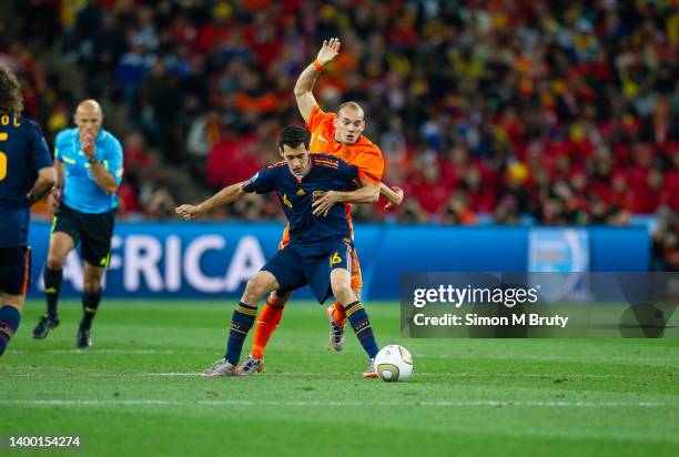 Sergio Busquets of Spain and Wesley Sneijer of Netherlands in action during the World Cup Final match between Spain and Netherlands at the FNB...