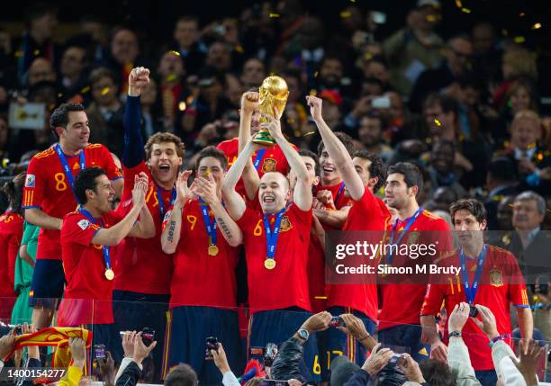 Andreas Iniesta of Spain and the goal scorer celebrates with the trophy and and the Spanish team after victory in the World Cup Final match between...