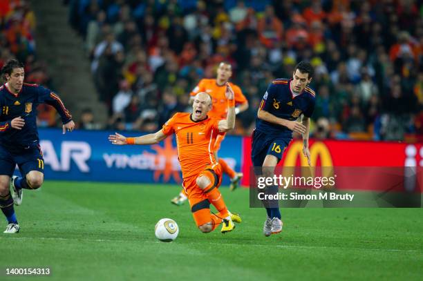 Arjen Robben of Netherlands and Sergio Busquets of Spain in action during the World Cup Final match between Spain and Netherlands at the FNB Stadium...