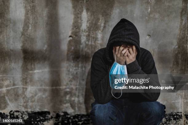 young student suffering from mental illness on campus - mental health awareness month stock pictures, royalty-free photos & images