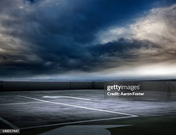 stormy carpark - sparse cloud stock pictures, royalty-free photos & images