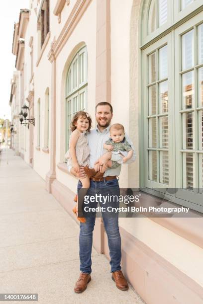 31-year-old american father holding his cuban-american 3-year-old daughter & 5-month-old son in palm beach, florida in the spring of 2022 - three year stock pictures, royalty-free photos & images