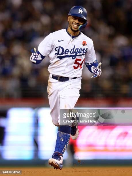 Mookie Betts of the Los Angeles Dodgers celebrates his solo homerun as he runs the bases, to trail 4-2 to the Pittsburgh Pirates, during the fifth...