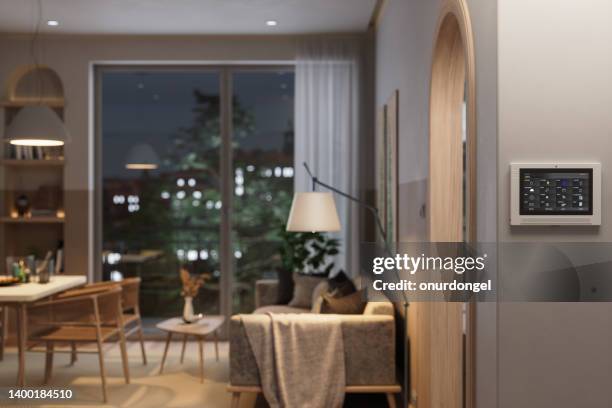 smart home automation system with in living room with blurred background - home automation stock pictures, royalty-free photos & images