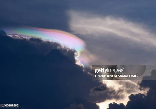 the rainbow corona over the dark cloud - ozonschicht stock-fotos und bilder