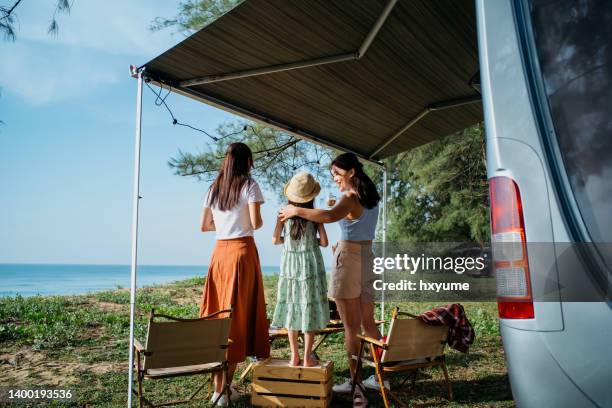 asian family camper van travel at the beach - awning stock pictures, royalty-free photos & images